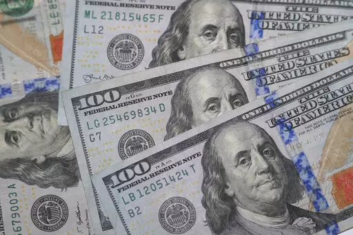 This Jan. 22, 2020, file photo shows the likeness of Benjamin Franklin on $100 bills in Dallas.  If you’re expecting a tax refund, you’re probably contemplating what to spend this newfound money on. There are several ways to use your windfall responsibly, but paying off debt could be the right option.  (AP Photo/LM Otero, File)