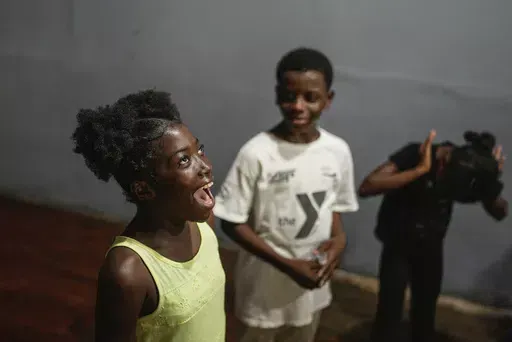 Juliana St. Vil, 12, who now lives in a shelter after fleeing gang violence in her neighborhood, rehearses her role in a skit for an acting workshop called “Theater Curbs Violence” in Port-au-Prince, Haiti, on Wednesday, May 15, 2024. The skit, which depicts life in a shelter in Haiti, will be performed for the public at the end of the two-week workshop. (AP Photo/Ramon Espinosa)