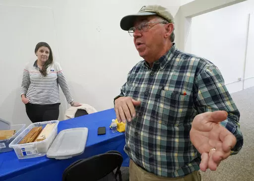 Co owner of Building Resilient Solutions, Kerry Shackelford, right, gestures as he describes the process for testing wood along with Paige Pollard, left, at their lab Tuesday, Oct. 4, 2022, in Suffolk, Va. Whenever historic homes get flooded, building contractors often feel compelled by government regulations to rip out the water-logged wood flooring, tear down the old plaster walls and install new, flood-resistant materials. But Virginia restorers Paige Pollard and Kerry Shackelford say they ca