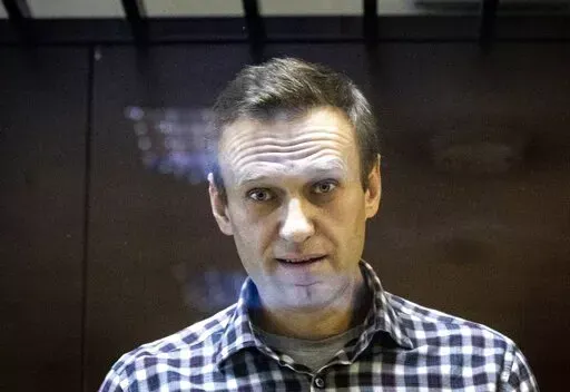 Russian opposition leader Alexei Navalny looks at photographers standing in the Babuskinsky District Court in Moscow, Russia, Saturday, Feb. 20, 2021. Jailed Russian opposition leader Alexey Navalny threw a bombshell Wednesday April 20, 2022 into France's tight and tense presidential election campaign, alleging that Russian leader Vladimir Putin may have bought off French far-right candidate Marine Le Pen with a bank loan. Navalny offered no proof of his allegation, and made it clear he supports
