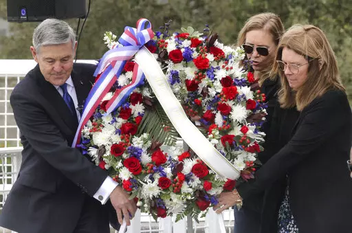 A wreath is presented by, from left, Bob Cabana, Associate Administrator of NASA; Janet Petro, NASA KSC director, and Sheryl Chaffee, daughter of Apollo 1 astronaut Roger Chaffee, during NASA's Day of Remembrance ceremony, hosted by the Astronauts Memorial Foundation at Kennedy Space Center Visitor Complex, Thursday, Jan. 26, 2023. NASA is marking the 20th anniversary of the space shuttle Columbia tragedy with somber ceremonies during its annual tribute to fallen astronauts. (Joe Burbank/Orlando