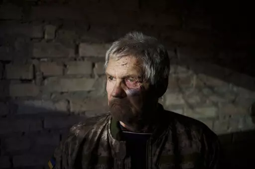 Anatolii Kaharlytskyi, 73, stands inside his house, heavily damaged after a Russian attack in Kyiv, Ukraine, Monday, Jan. 2, 2023. Kaharlytskyi was injured and his daughter in law Iryna died in the attack on Dec. 31, 2022. (AP Photo/Renata Brito)