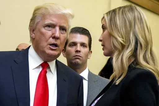 Donald Trump, left, his son Donald Trump Jr., center, and his daughter Ivanka Trump speak during the unveiling of the design for the Trump International Hotel in the The Old Post Office, in Washington, on  Sept. 10, 2013. The former, his namesake son and his daughter have agreed to answer questions under oath next month in the New York attorney general's civil investigation into his business practices, unless their lawyers persuade the state's highest court to step in. A Manhattan judge signed o