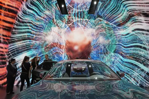 Attendees look at the electric Han EV sedan from Chinese automaker BYD during the Auto Shanghai 2023 show in Shanghai, on April 19, 2023. Threatened by possible shortages of lithium for electric car batteries, automakers are racing to lock in supplies of the once-obscure "white gold" in a politically and environmentally fraught competition from China to Nevada to Chile. General Motors Co. and the parent company of China's BYD Auto Ltd. went straight to the source and bought stakes in lithium min