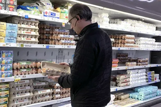A shopper checks eggs before he purchases at a grocery store in Glenview, Ill., Tuesday, Jan. 10, 2023. (AP Photo/Nam Y. Huh, File)
