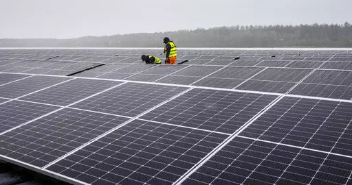 Solar panels are installed at a floating photovoltaic plant on a lake in Haltern, Germany, on April 1, 2022. Russia's Gazprom says it is halting natural gas supplies to Poland and Bulgaria, escalating tensions between the Kremlin and Europe over energy and Russia's invasion of Ukraine — and adding new urgency to plans to reduce and then end the continent's dependence on Russia as a supplier of oil and gas. (AP Photo/Martin Meissner)