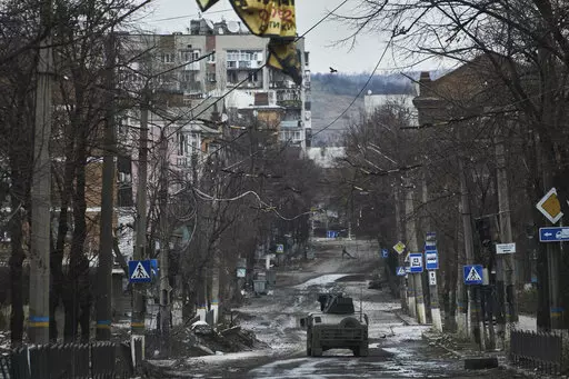 Ukrainian soldiers ride in a Humvee in Bakhmut, Donetsk region, Ukraine, Wednesday, Dec. 21, 2022. (AP Photo/Libkos, File)