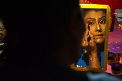 Prastuti Parashar, owner and lead actor of Awahan theater, prepares for a performance at Xetali village, east of Gauhati, India, Wednesday, April 6, 2022. Traveling theater groups in India's northeastern state of Assam are reviving the local art and culture scene after the COVID-19 pandemic forced a pause in their performances for a year and a half. “The public response has been very good. They love live performances. We have no competition from television and the digital boom,” said Parasha
