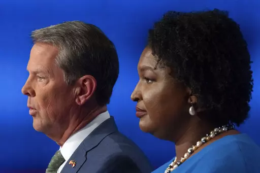 Republican Georgia Gov. Brian Kemp, left, and Democratic challenger Stacey Abrams face off in a televised debate, in Atlanta, Sunday, Oct. 30, 2022. (AP Photo/Ben Gray)