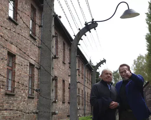 Arnold Schwarzenegger, right, and Simon Bergson, chairman of The Auschwitz Jewish Center Foundation visit Auschwitz - Birkenau Nazi German death camp in Oswiecim, Poland, Wednesday, Sept. 28, 2022. Film icon Schwarzenegger visited the site of the Nazi German death camp Auschwitz on Wednesday to send a message against hatred. The "Terminator" actor was given a tour of the site, viewing the barracks watchtowers and the remains of gas chambers that endure as evidence of the German extermination of 