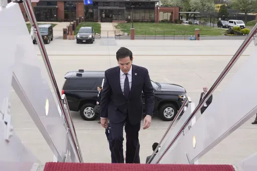 Secretary of State Marco Rubio boards his plane at Joint Base Andrews, Md., Wednesday, April 2, 2025, en route to NATO in Belgium. (AP Photo/Jacquelyn Martin, Pool)