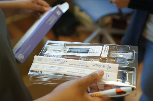 A home COVID-19 test kit is held, Feb. 3, 2022, in Seattle.  Medicare says that millions of enrollees will finally have access to free over-the-counter COVID-19 tests at drug stores. Monday's announcement comes amid worries that the latest coronavirus variant __ BA.2 __ will spark another rise in U.S. cases. (AP Photo/Ted S. Warren, File)