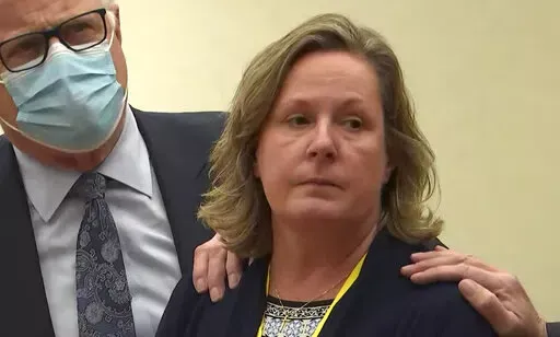 In this screen grab from video, former Brooklyn Center Police Officer Kim Potter stands with defense attorney Earl Gray, as the verdict is read Thursday, Dec.,23, 2021 at the Hennepin County Courthouse in Minneapolis, Minn.  Jurors on Thursday convicted Potter of two manslaughter charges in the killing of Daunte Wright, a Black motorist she shot during a traffic stop after she said she confused her gun for her Taser.(Court TV via AP, Pool)