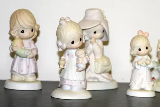 A selection of Precious Moments figurines sit on a shelf, Thursday, May 23, 2024, in Blaine, Minn. Sam Butcher, the artist who created the Precious Moments figurines depicting angelic teardrop-eyed children, died early Monday, May 20, 2024, surrounded by family. He was 85. (Lissa Forliti-Aska via AP)