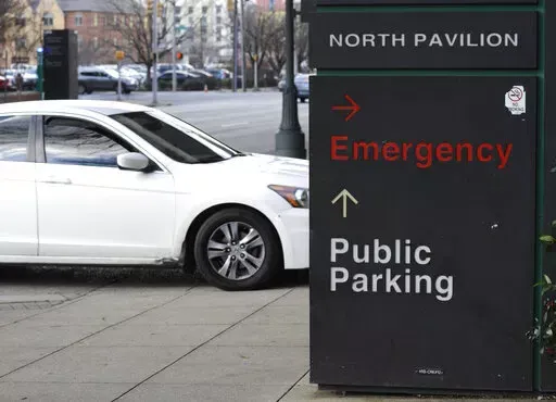 A car pulls into the emergency room entrance at UAB Hospital in Birmingham, Ala., on Wednesday, Jan. 5, 2022.   On Friday, Jan. 28, The Associated Press reported on stories circulating online incorrectly claiming vaccines only reduce hospitalizations in the U.S., not in other countries. (AP Photo/Jay Reeves, File)