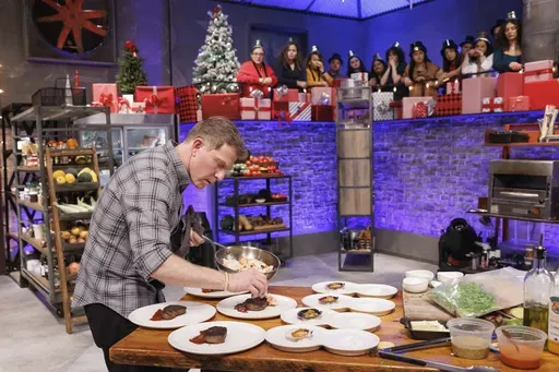 This image released by The Food Network shows Bobby Flay during an episode of the cooking series "Beat Bobby Flay: Holiday Throwdown." (Stephen Davis Phillips/Food Network via AP)