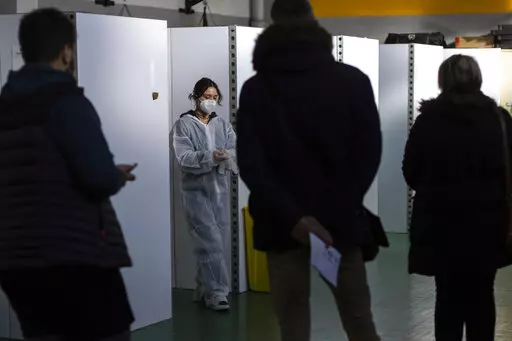 A medical worker prepares to perform nasal tests, at a COVID-19 testing site, in Nantes, western France, Friday, Dec. 31, 2021. An unprecedented number of coronavirus infections is once again exposing the underfunding and shortcomings of public health care systems, even in developed parts of Europe. (AP Photo/Jeremias Gonzalez, File)