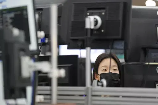 A currency trader watches computer monitors at a foreign exchange dealing room in Seoul, South Korea, Tuesday, Oct. 25, 2022. Shares advanced Tuesday in Asia after Wall Street shook off an early bout of unsettled trading and ended higher. (AP Photo/Lee Jin-man)