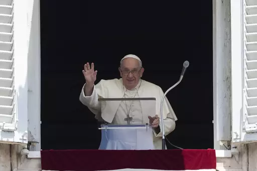 Pope Francis waves as he arrives for the Angelus noon prayer from the window of his studio overlooking St.Peter's Square, at the Vatican, Sunday, July 2, 2023. (AP Photo/Alessandra Tarantino)
