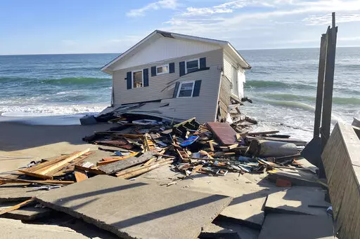 This image released by the National Park Service, shows a collapsed beachfront home along Ocean Drive in Rodanthe, N.C., on Wednesday, Feb. 9, 2022. The National Park Service issued a warning to visitors on Wednesday for debris. (National Park Service via AP, File)