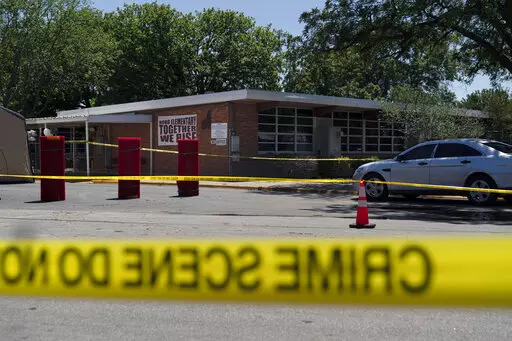 Crime scene tape surrounds Robb Elementary School in Uvalde, Texas, Wednesday, May 25, 2022. Desperation turned to heart-wrenching sorrow for families of grade schoolers killed after an 18-year-old gunman barricaded himself in their Texas classroom and began shooting, killing at least 19 fourth-graders and their two teachers. (AP Photo/Jae C. Hong)
