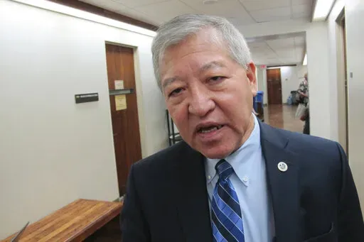 Honolulu Prosecuting Attorney Keith Kaneshiro talks to The Associated Press in Honolulu, on March 2, 2016. A U.S. grand jury has indicted Honolulu's former top prosecutor, Kaneshiro, and four others, alleging employees of an engineering and architectural firm bribed Kaneshiro with campaign donations in exchange for his prosecution of a former company employee. (AP Photo/Cathy Bussewitz, File)