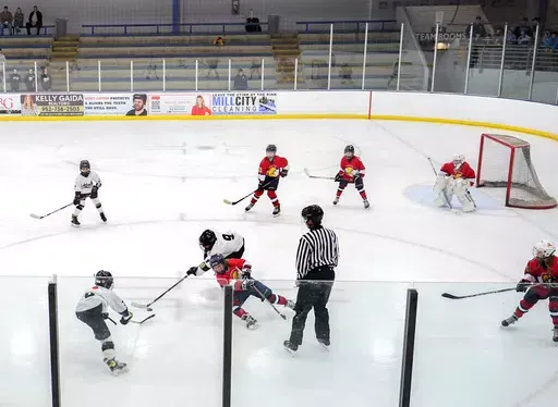 Players on the Minneapolis, wearing white and black uniforms, and Orono, wearing red uniforms, teams compete in a 10-and-under youth hockey game Feb. 4, 2024, in Minneapolis. While Canada has seen a steep decline in children playing hockey in the sport's birthplace, the United States has experienced steady growth in that department over the past decade. (AP Photo/Abbie Parr, File)
