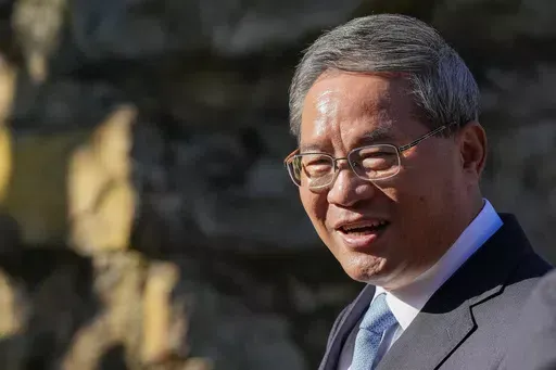 Chinese Premier Li Qiang reacts during a visit to Adelaide Zoo, Australia, Sunday, June 16, 2024. Li is on a relations-mending mission with panda diplomacy, rock lobsters and China's global dominance in the critical minerals sector high on the agenda during his four day visit to Australia. (Asanka Brendon Ratnayake/Pool Photo via AP)