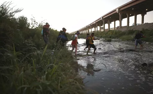 Venezuelan migrants walk across the Rio Bravo towards the United States border to surrender to the border patrol, from Ciudad Juarez, Mexico, Oct. 13, 2022. A surge in migration from Venezuela, Cuba and Nicaragua in September brought the number of illegal crossings to the highest level ever recorded in a fiscal year, according to U.S. Customs and Border Protection. (AP Photo/Christian Chavez, File)