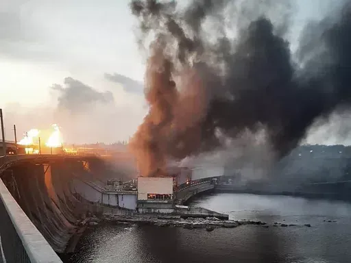 In this photo provided by Telegram Channel of Ukraine's Prime Minister Denys Shmyhal, smoke and fire rise over the Dnipro hydroelectric power plant after Russian attacks in Dnipro, Ukraine, Friday, March 22, 2024. (Telegram Channel of Ukraine's Prime Minister Denys Shmyhal via AP)