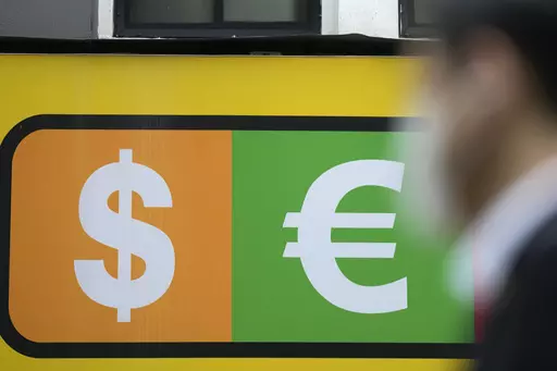 A man walks near a sign of foreign currency outside a money exchange office at a shopping district in Seoul, South Korea, Thursday, April 6, 2023. Asian shares were trading mostly lower Thursday as investors turned their attention to upcoming earnings reports and other economic indicators.(AP Photo/Lee Jin-man)