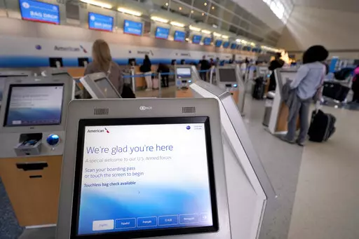Travelers use kiosk to check their bags as they arrive to travel out of Dallas/Fort Worth International airport Tuesday, Nov. 22, 2022, in Grapevine, Texas.  Pandemic rebooking issues drove many air passengers to book directly with airlines instead of third-party travel sites. While ancillary fees have become a major part of airline revenue over the past 15 years, airlines have more recently ramped up efforts to drive revenue from add-on fees. (AP Photo/Tony Gutierrez)