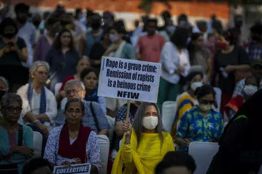 A woman holds a placard during a protest against remission of sentence by the government to convicts of a gang rape of a Muslim woman, in New Delhi, India, Saturday, Aug. 27, 2022. The victim, who is now in her 40s, was pregnant when she was brutally gang raped in communal violence in 2002 in the western state of Gujarat, which saw over 1,000 people, mostly Muslims, killed in some of the worst religious riots India has experienced since its independence from Britain in 1947.  (AP Photo/Altaf Qad
