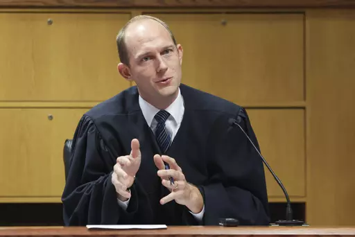 Fulton County Superior Judge Scott McAfee hears motions from attorneys representing Ken Chesebro and Sidney Powell in Atlanta on Wednesday, Sept. 6, 2023. Past high-profile trials suggest additional scrutiny and stress for the four judges overseeing the indictments against former President Donald Trump. But the challenge facing Fulton County Judge Scott McAfee in Georgia is unlike any of the others. (Jason Getz/Atlanta Journal-Constitution via AP, Pool, File)