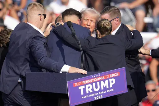 Republican presidential candidate former President Donald Trump is surrounded by Secret Service at a campaign event in Butler, Pa., July 13, 2024. A senior FBI official says the gunman in the assassination attempt of former President Donald Trump searched online for events of both Trump and President Joe Biden and saw the Pennsylvania campaign rally where he opened fire last month as a “target of opportunity." (AP Photo/Gene J. Puskar, File)