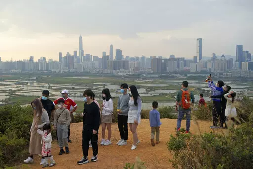 People visit the border of Hong Kong, with the skyline of China's Shenzhen in the background, in Hong Kong Feb. 13, 2021. Hong Kong will start to reopen its border with mainland China on Sunday, Jan. 8, 2023, allowing tens of thousands of people to travel between both sides each day under a quarantine-free arrangement, the city's leader said Thursday, Jan. 5. (AP Photo/Kin Cheung, File)