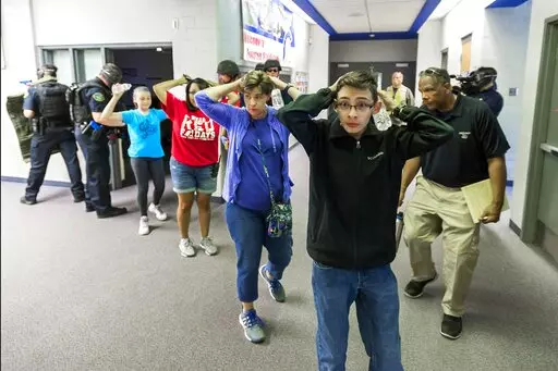Students are led out of school as members of the Fountain Police Department take part in an Active Shooter Response Training exercise at Fountain Middle School in Fountain, Colo., on June 9, 2017. Since 2012, a total of 73 students have been killed in school shootings with at least four victims shot and two victims killed, according to research by James Alan Fox, a criminologist at Northeastern University who studies mass killings. (Dougal Brownlie/The Gazette via AP, File)