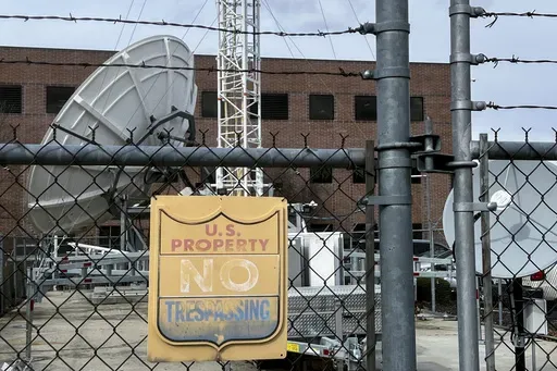 A chain link fence protects a satellite station and other equipment behind the Bureau of Reclamation office Thursday, March 13, 2025, in Boise, Idaho. (AP Photo/Rebecca Boone)