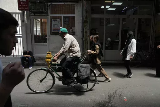 People make their way through the old main bazaar of Tehran, Iran, Thursday, June 13, 2024. The rise of the “Hamster Kombat” app in Iran highlights a harsher truth facing the Islamic Republic's economy ahead of its presidential election this week to replace the late President Ebrahim Raisi, who died in a helicopter crash in May. (AP Photo/Vahid Salemi)