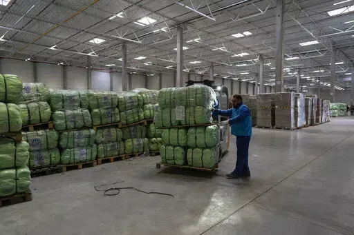 UNHCR staff load a truck with supplies for Ukraine in an aid warehouse at Rzeszow airport, in Rzeszow, southeastern Poland, Wednesday, March 16, 2022. (AP Photo/Petros Giannakouris)