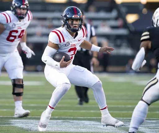 Mississippi quarterback Jaxson Dart (2) scrambles past the Vanderbilt defense during the third quarter of an NCAA college football game Saturday, Oct. 8, 2022, in Nashville, Tenn. (George Walker IV/The Tennessean via AP)