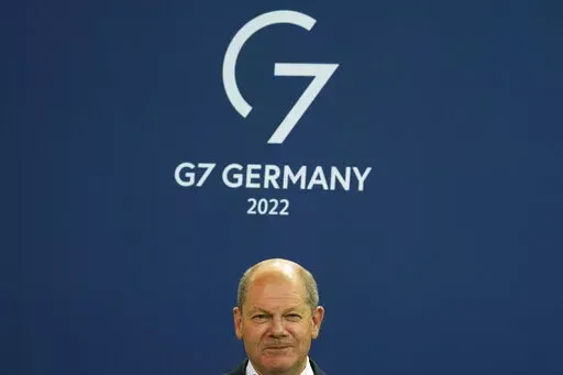 German Chancellor Olaf Scholz attends the presentation of a special stamp of the German mail service Deutsche Post for the upcoming G7 summit, at the chancellery in Berlin, Germany, Wednesday, June 15, 2022. Three back-to-back summits over the next week will test Western resolve to support Ukraine and the extent of international unity as rising geopolitical tensions and economic pain cast an increasingly long shadow. (AP Photo/Markus Schreiber, File)