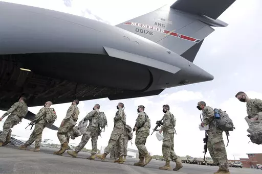 Tennessee National Guard troops board a plane in Smyrna, Tenn., to go to Washington, Thursday, June 4, 2020.  Three current and former members of the Tennessee National Guard are “safe” and “accounted for,” despite a Russian newspaper’s false report, Thursday, March, 17, 2022, that the men were killed while fighting in Ukraine.  All three individuals named in the report, are alive and well — and no U.S. military personnel are currently on orders in Ukraine, National Guard Bureau spok