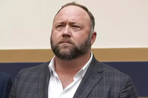 This Tuesday, Dec. 11, 2018, file photo shows radio show host and conspiracy theorist Alex Jones at Capitol Hill in Washington. Infowars host Jones has offered to pay $120,000 per plaintiff to resolve a lawsuit by relatives of Sandy Hook Elementary School shooting victims who said he defamed them by asserting the massacre never happened, according to court filings Tuesday, March 29, 2022. (AP Photo/J. Scott Applewhite, File)