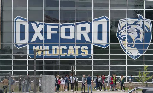 Oxford High School student return to school after they walked out of classes on May 26, 2022, in Oxford, Mich., to show their support for the Uvalde, Texas community and the recent mass shooting that occurred at an elementary school. About 20 students at the Michigan high school where four students were killed in a mass shooting say their constitutional rights to safety and education were violated and that they want changes to ensure security at school, a law firm representing them said Friday, 