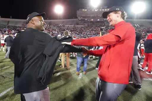 Texas Tech interim head coach Sonny Cumbie, right, celebrates with associate head coach Derek Jones after Texas Tech beat Mississippi State 34-7 in the Liberty Bowl NCAA college football game Tuesday, Dec. 28, 2021, in Memphis, Tenn. (AP Photo/Mark Humphrey)