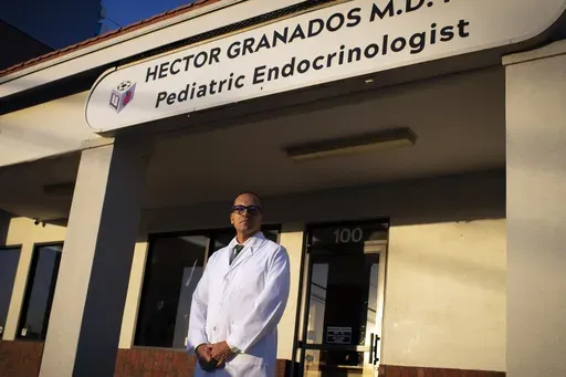Pediatric endocrinologist Dr. Hector Granados poses for a photo outside his private practice in El Paso, Texas, Tuesday, Jan. 21, 2025. (AP Photo/Andres Leighton)