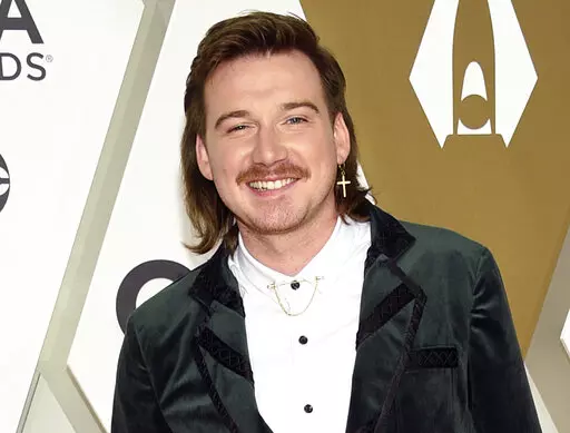 Morgan Wallen arrives at the 53rd annual CMA Awards on Nov. 13, 2019, in Nashville, Tenn. The Grand Ole Opry, country music's most historic and storied stage, is getting heavy criticism for an appearance by the country star. Wallen's surprise performance has given many the impression that the institution has given the star its blessing and a path to reconciliation after he was caught on camera last year using a racial slur. (Photo by Evan Agostini/Invision/AP, File)