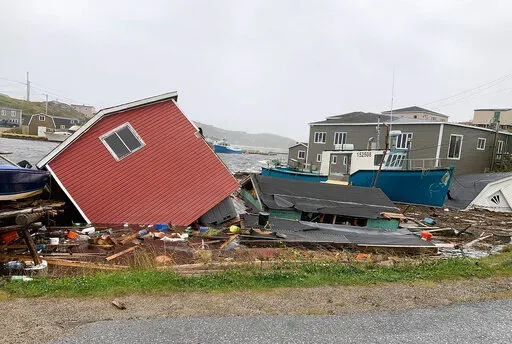 This photo provided by Pauline Billard shows destruction caused by Hurricane Fiona in Rose Blanche, 45 kilometers (28 miles)  east of Port aux Basques, Newfoundland and Labrador, Saturday, Sept. 24, 2022. (Pauline Billard via AP)