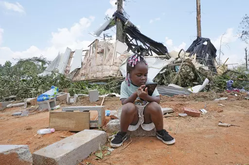Genesis Jackson, three, sits in front of a relative's home following an apparent Sunday night tornado that swept through the small community of Louin, Miss., Monday, June 19, 2023. Possible multiple tornadoes swept through Mississippi overnight, killing one and injuring nearly two dozen, officials said Monday. (AP Photo/Rogelio V. Solis)